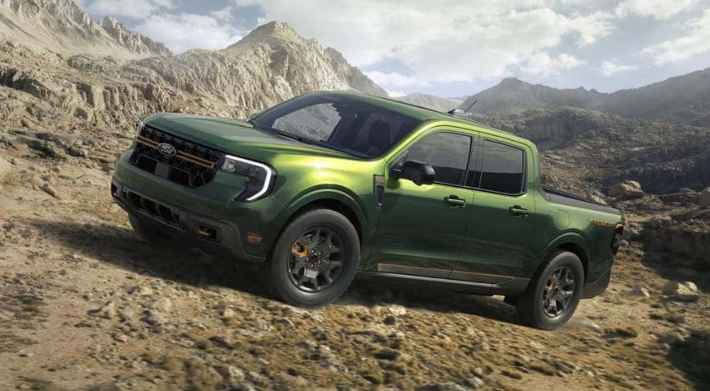 A green 2025 Ford Maverick for sale is off-roading.