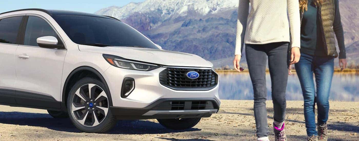 A white 2023 Ford Escape parked near a lake.