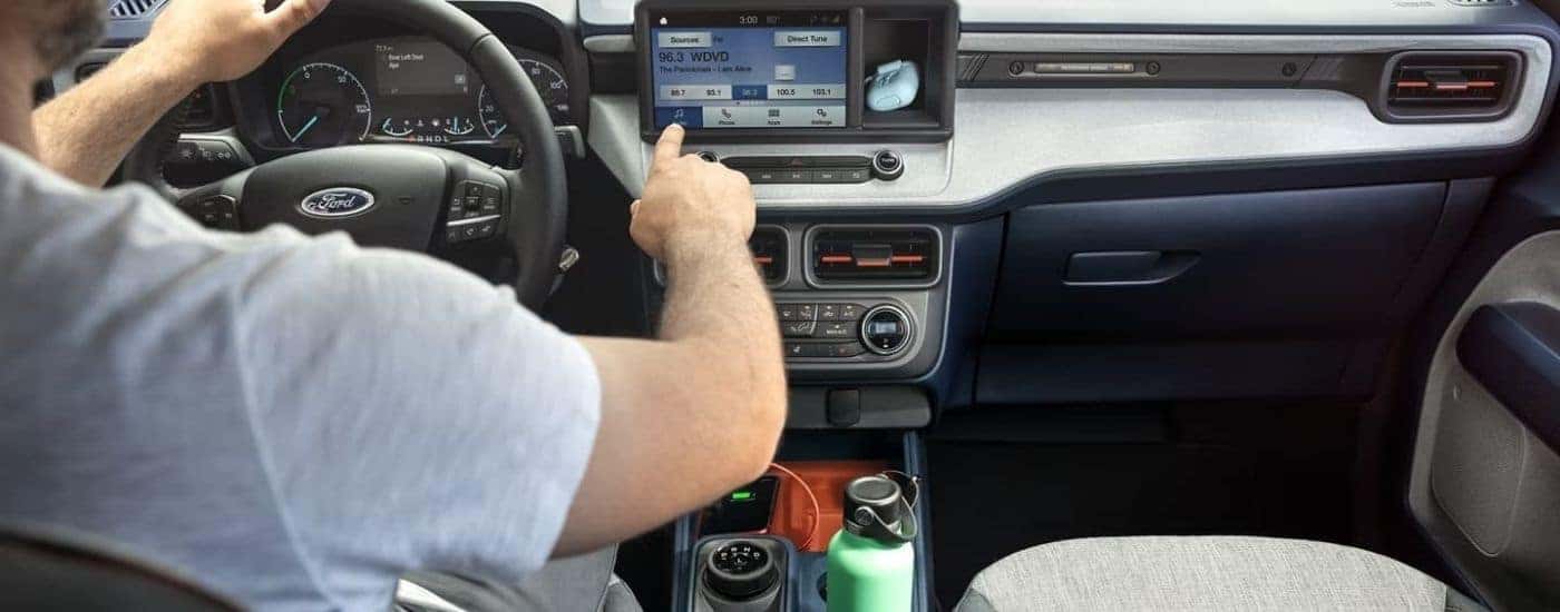 Person using the infotainment screen in a 2022 Ford Maverick.