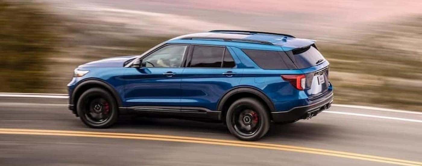 A blue 2020 Ford Explorer ST driving to view a used Ford for sale in Hendersonville.