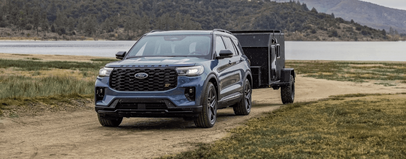A blue 2025 Ford Explorer for sale near Boiling Springs towing a trailer.