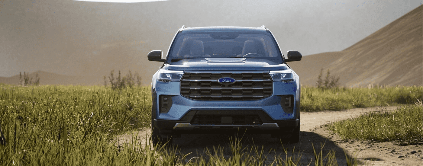 A blue 2025 Ford Explorer for sale near Candler parked off-road.