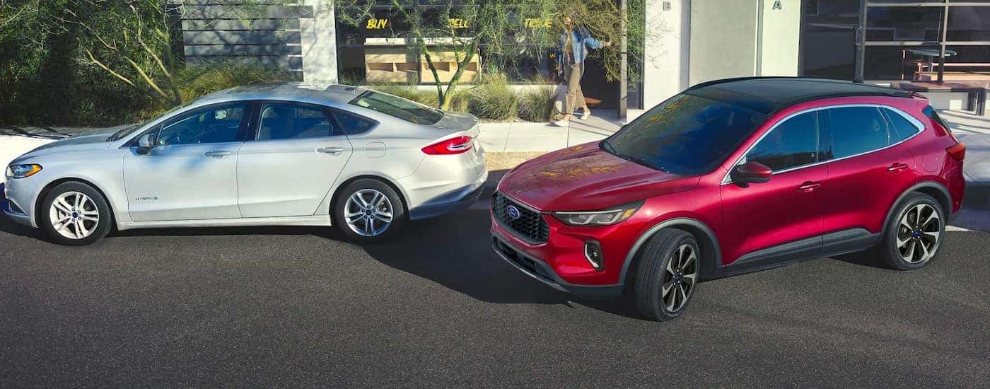 A red used 2023 Ford Escape parking with park assist