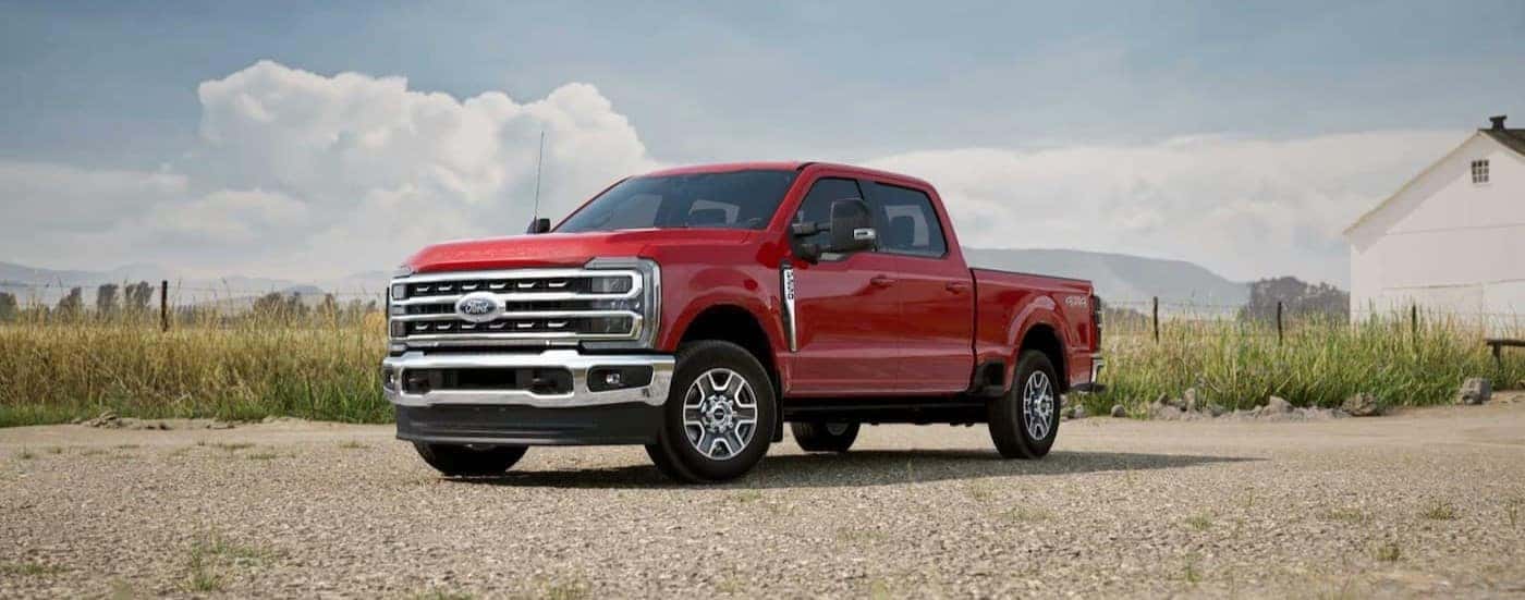 A red 2025 Ford F-250 for sale parked off-road.