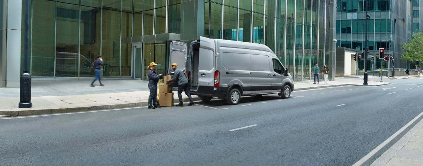 A grey 2025 Ford Transit for sale from the rear.