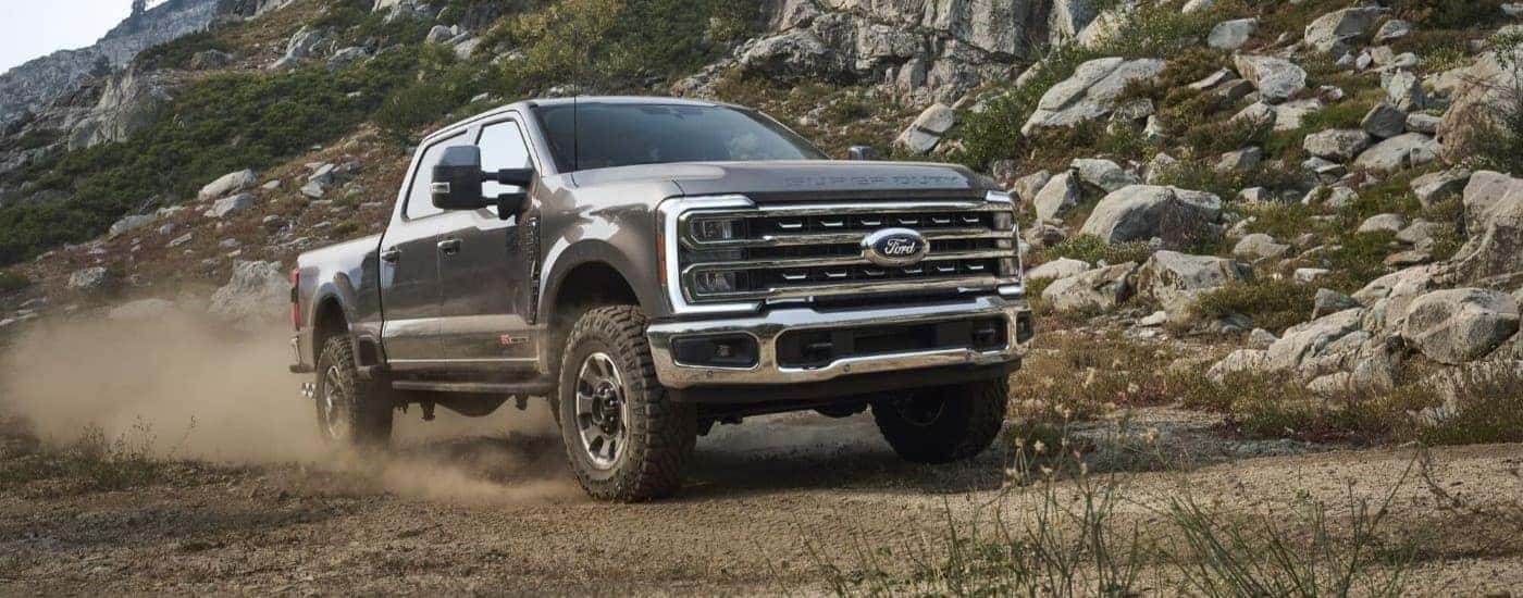 A gray 2025 Ford F-250 driving off-road.