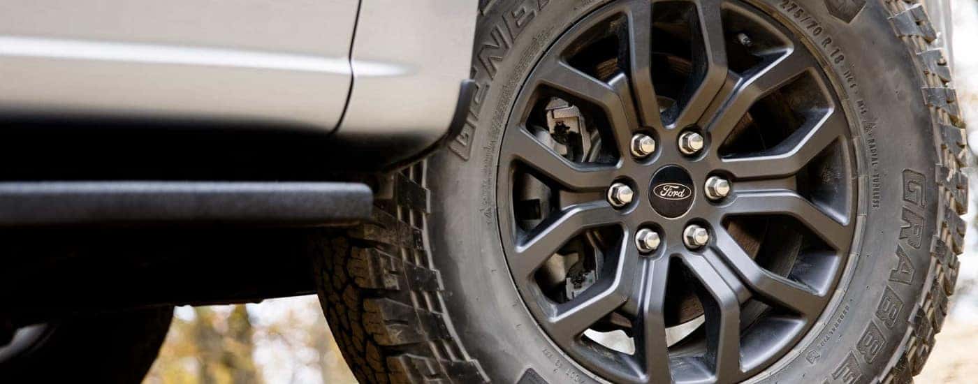 Black wheel on a white 2024 Ford F-150 for sale near you.