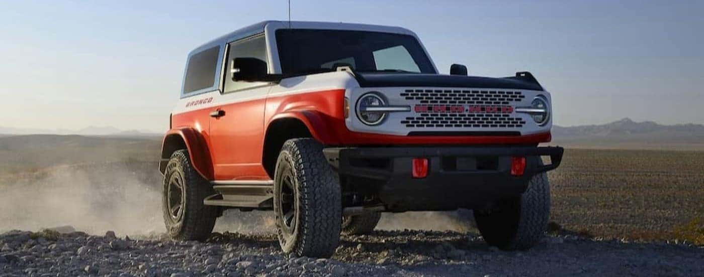 A multi-colored Ford Bronco Stroppe Edition parked off-road.