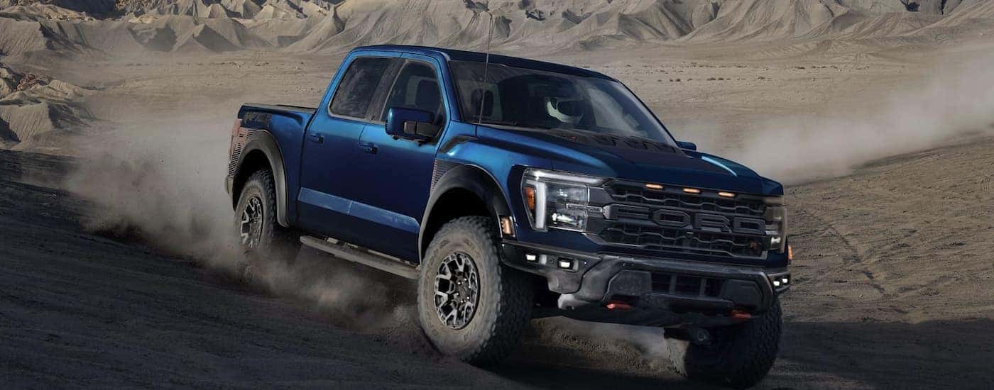 Blue 2025 Ford F-150 Raptor for sale near Boiling Springs driving off-road.