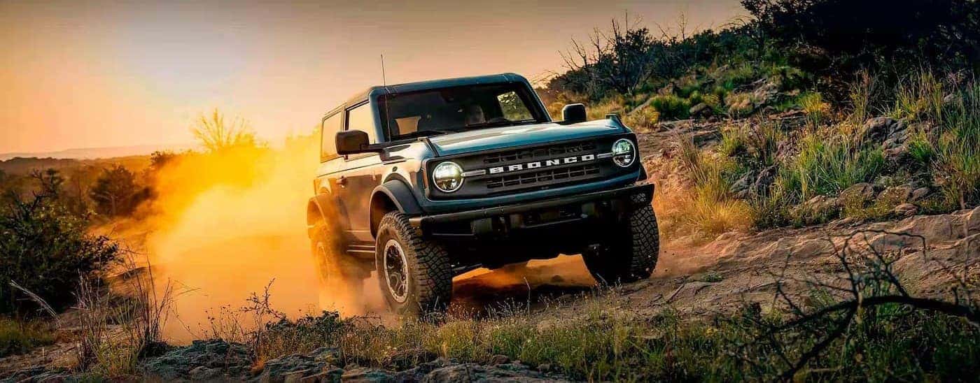 A blue 2024 Ford Bronco Badlands off-roading.