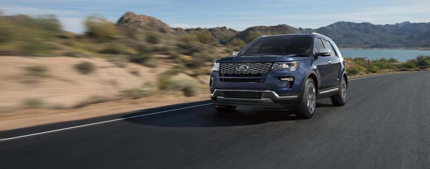 Blue 2018 Ford Explorer driving to see a new Ford Explorer for sale near Easley
