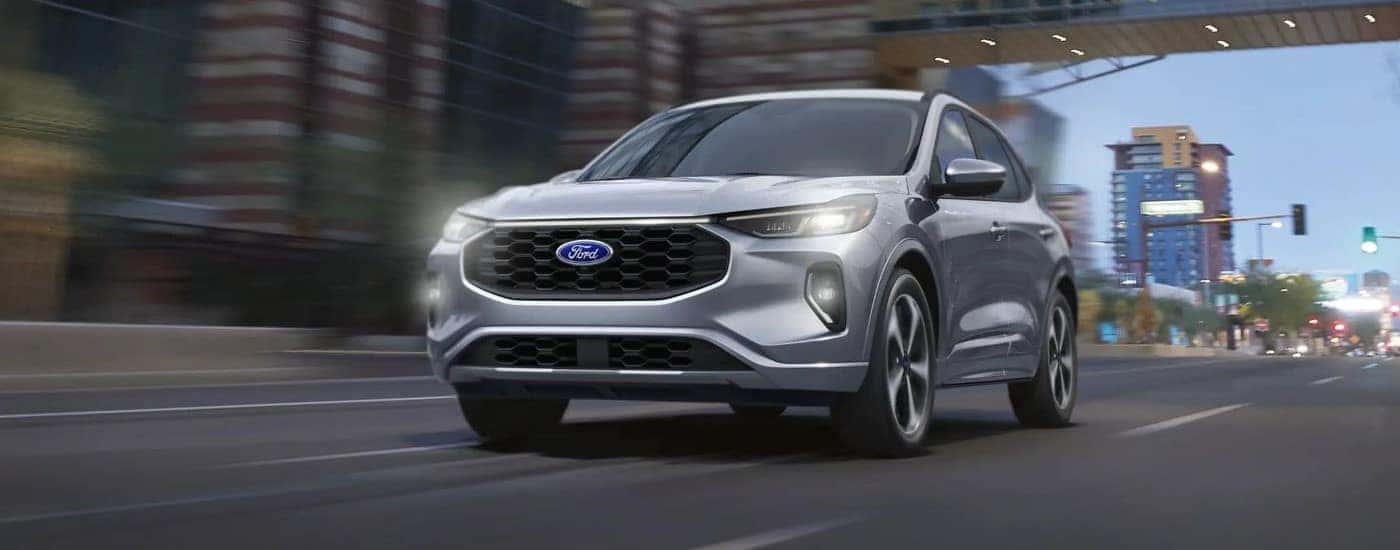 Silver 2023 Ford Escape driving to look at cars for sale near Easley
