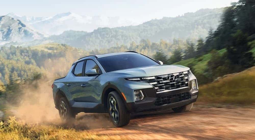 A blue 2024 Hyundai Santa Cruz off-roading.