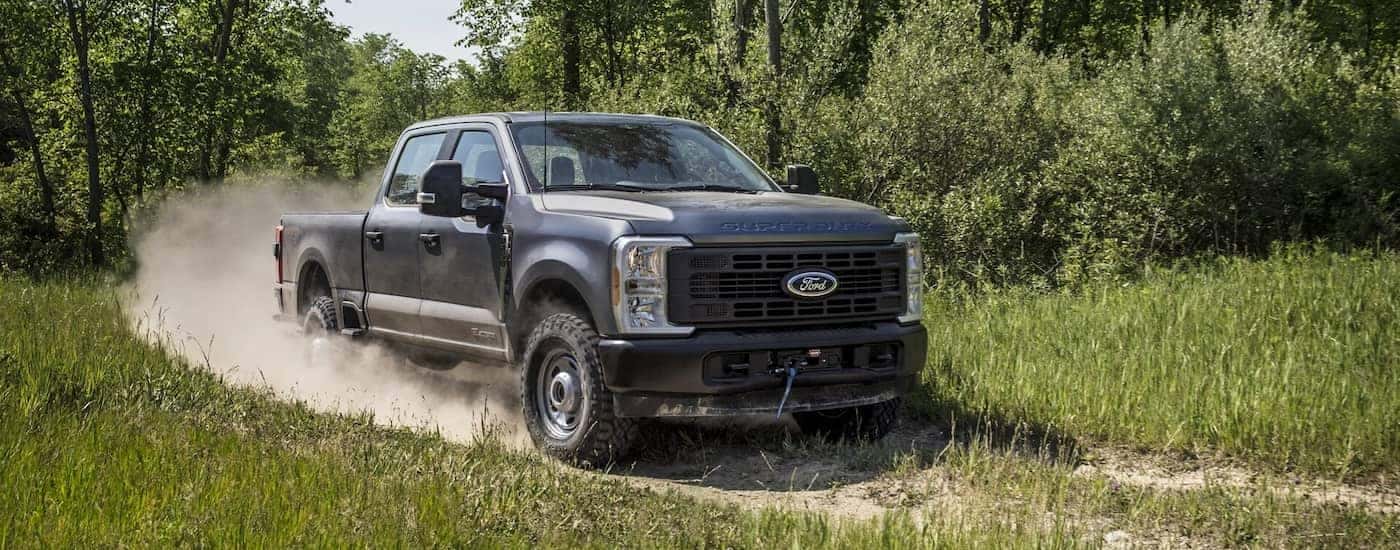 Grey 2025 Ford F-250 driving around a bend.