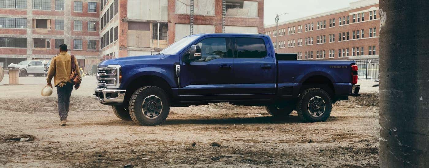 Side of a dark blue 2026 Ford F-350 parked at a construction zone.