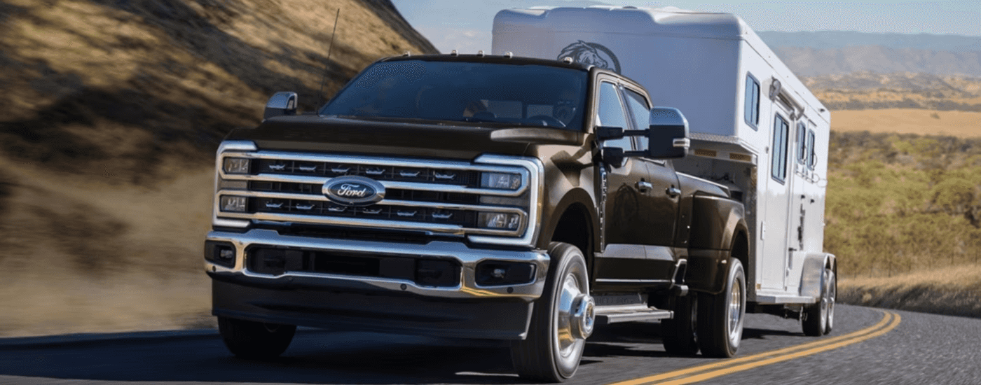 Brown 2026 Ford F-350 Super Duty towing a camper