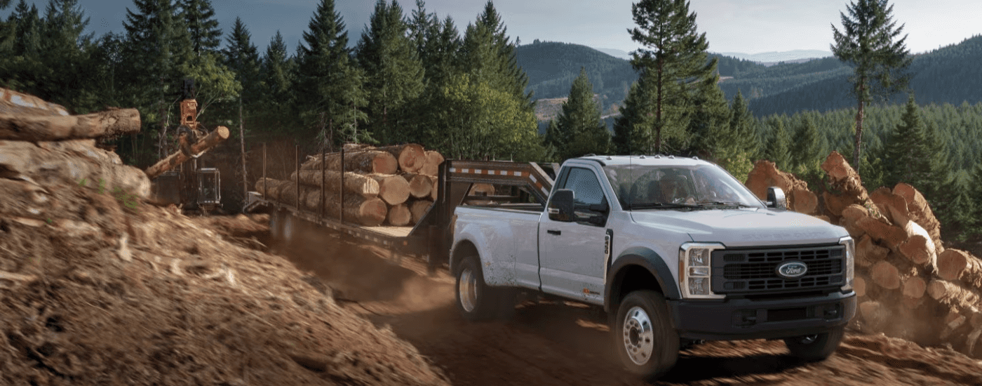 White 2026 Ford F-450 Super Duty towing logs