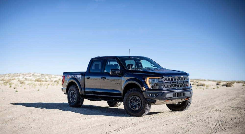 A black 2022 F-150 Raptor R parked off-road.