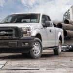 A silver 2015 Ford F-150 is shown parked at a construction site.
