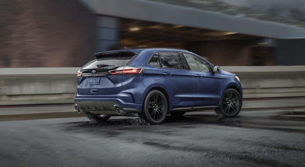 A blue 2022 Ford Edge is driving to a Corunna Ford dealership.