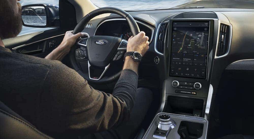 The black interior and infotainment screen in 2022 Ford Edge.