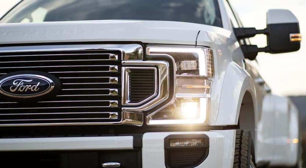 A white 2022 Ford F-350 is shown at a Owosso Ford dealer.