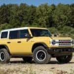 A yellow 2023 Ford Bronco Heritage Edition is shown from the side at an angle.
