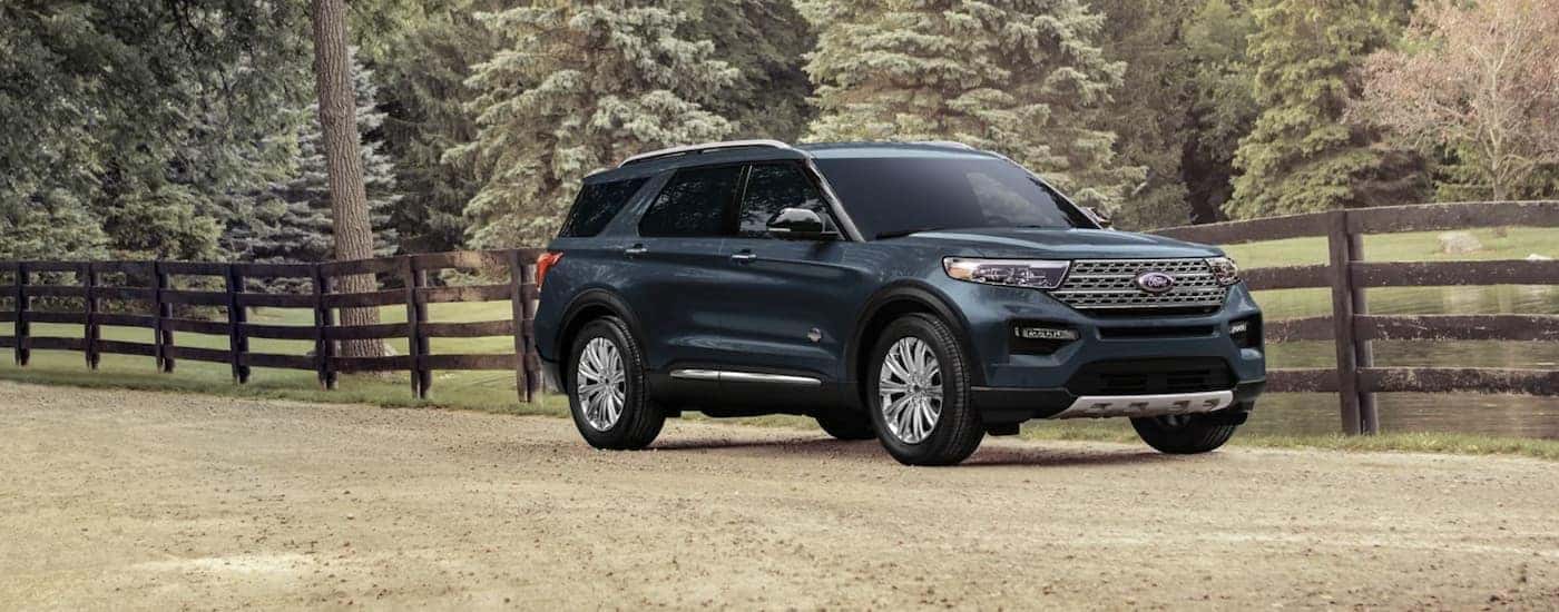 A blue 2023 Ford Explorer is parked near an Owosso Ford dealer.