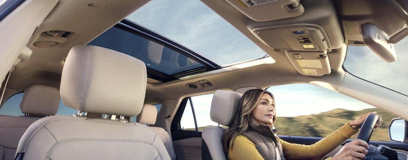 The person is driving a 2022 Ford Explorer to a used car dealer near you.
