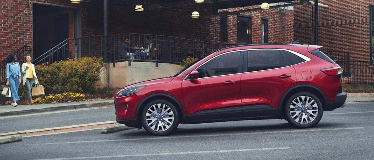 A red 2022 Ford Escape is parked in front of a brick buidling.