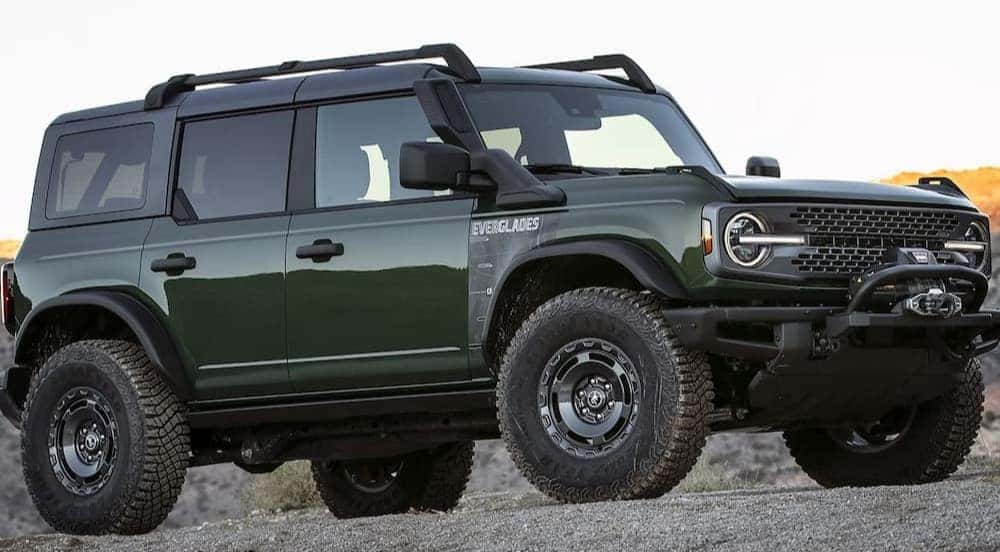 A green 2024 Ford Bronco Everglades is parked off-road.