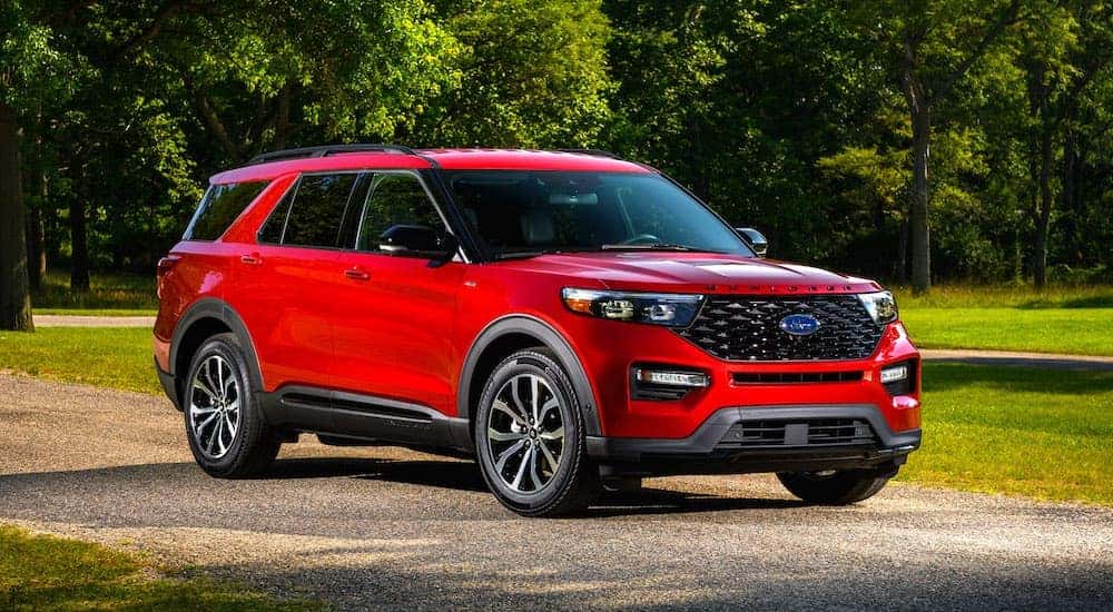 A red 2022 Ford Explorer ST Line is parked on pavement.