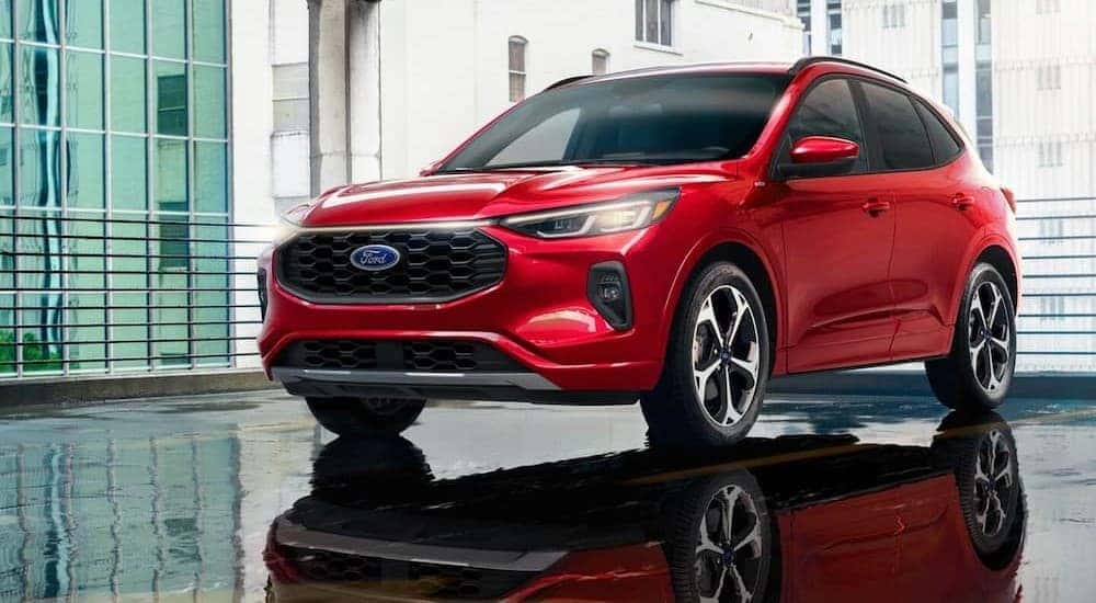 A red 2024 Ford Escape is shown parked on a parking spot.