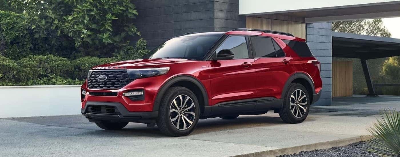 A red 2023 Ford Explorer ST-Line is shown parked on a driveway.