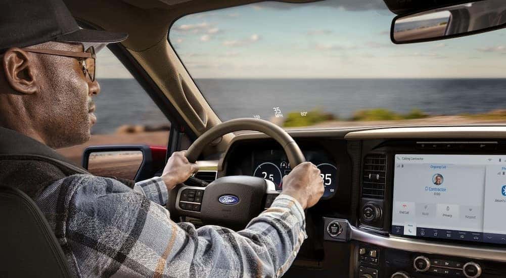 The black and tan interior and dash are shown in a 2025 Ford F-150 King Ranch.