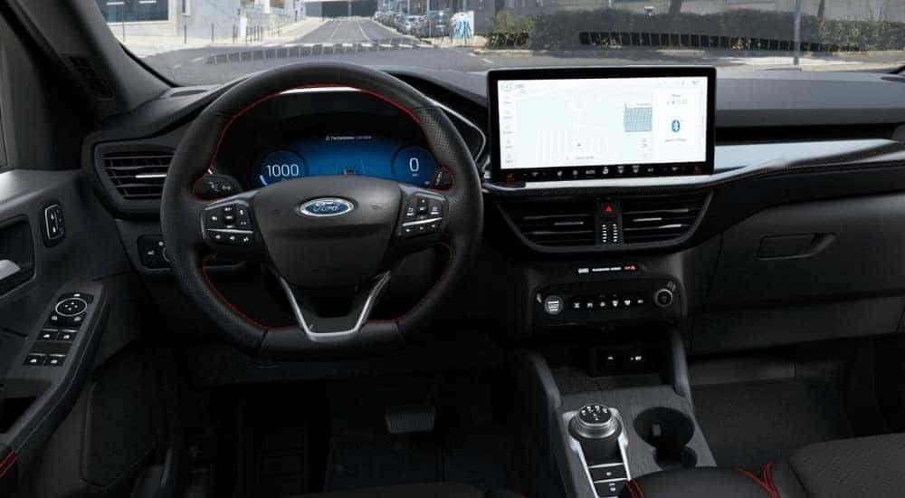 The steering wheel and infotainment screen in a 2025 Ford Escape.