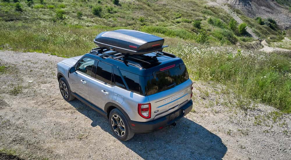 A silver 2025 Ford Bronco for sale in Saint Johns is parked off-road.