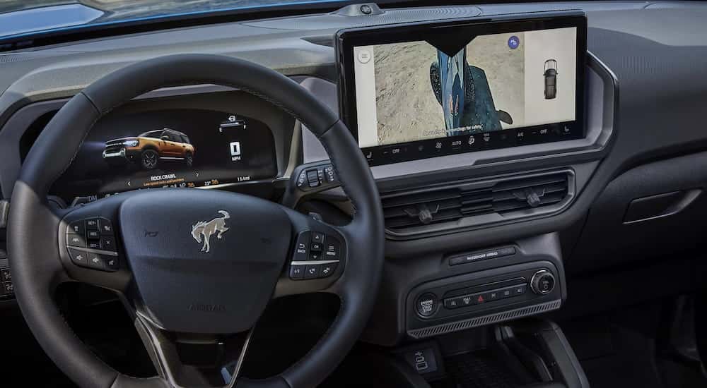 The steering wheel and black interior in a 2025 Ford Bronco Sport.
