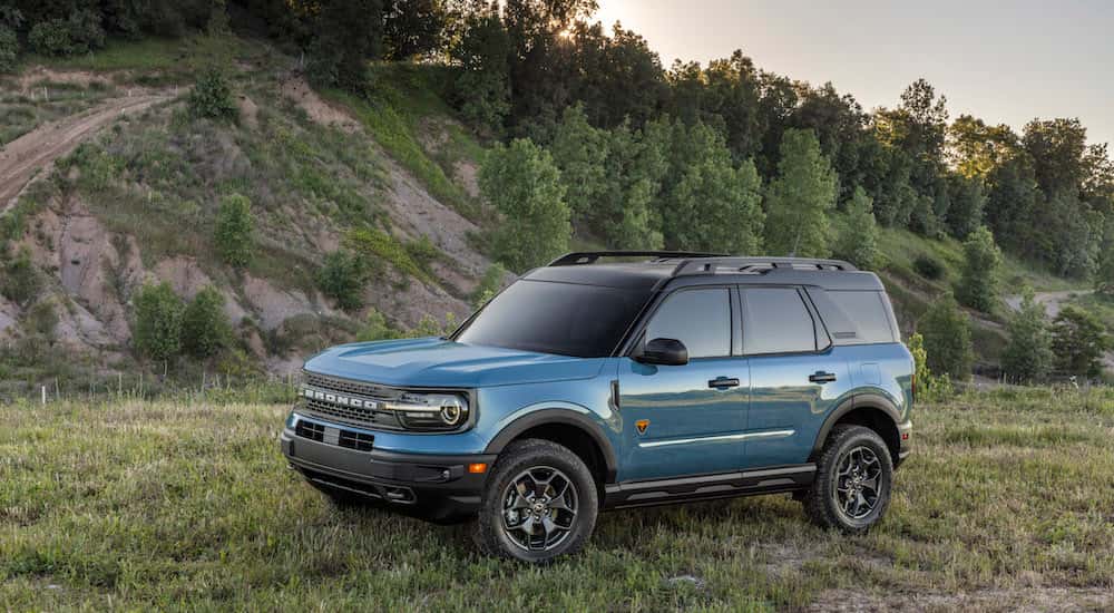 A blue 2024 Ford Bronco Sport is parked off-road.