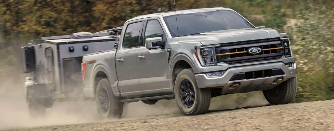 A white 2024 Ford F-150 Tremor towing a trailer.