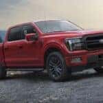 A red 2025 Ford F-150 for sale near Lansing parked off-road.