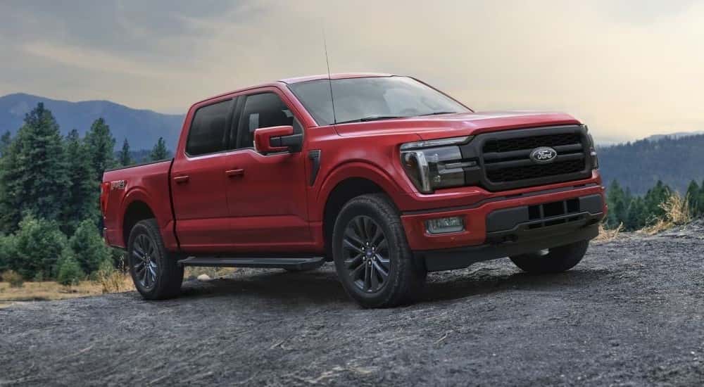 A red 2025 Ford F-150 for sale near Lansing parked off-road.