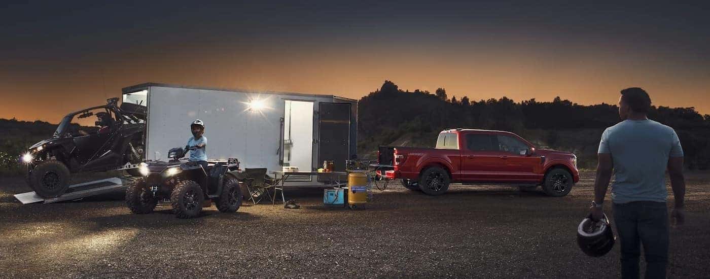 A red 2025 ford F-150 for sale near Ionia from the side.