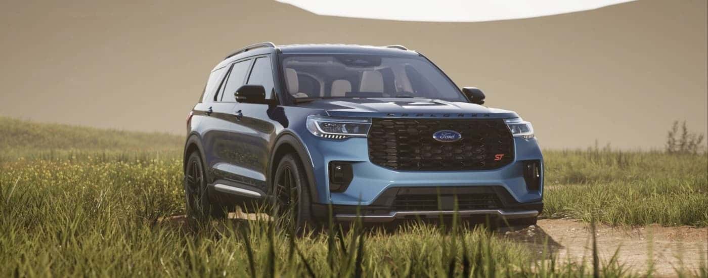A blue 2025 Ford Explorer for sale near Grand Ledge parked off-road.