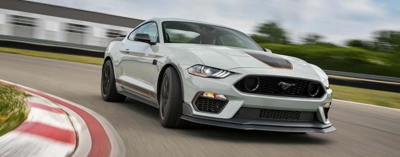 A grey 2022 Ford Mustang Mach1 driving to a Ford dealer in Saint Johns.