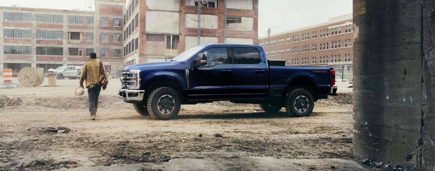 A blue 2025 Ford F-250 Lariat Tremor parked near a building after leaving a Ford dealership in Central Michigan.