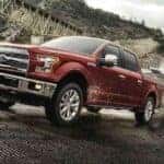 A red 2017 Ford F-150 towing a boat.