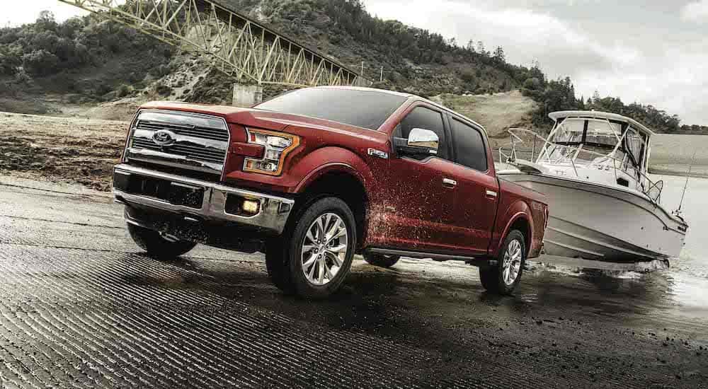 A red 2017 Ford F-150 towing a boat.