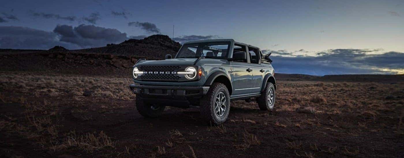 Grey 2024 Ford Bronco Badlands for sale near Holt parked off-road.