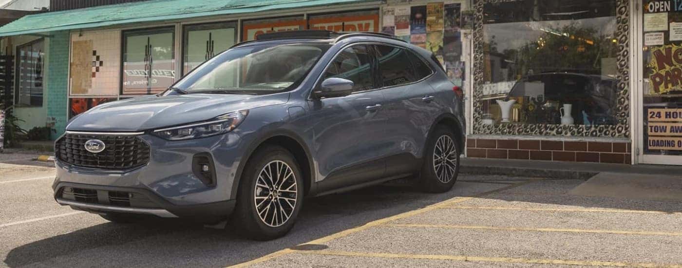Grey 2023 Ford Escape parked outside a shop